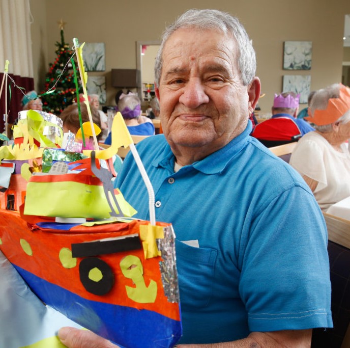 Elderly man with a craft project