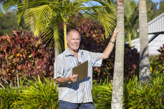 older man outside with clipboard